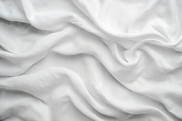 Obraz premium Textured white fabric drapes softly, creating a serene and elegant backdrop for various design projects and photography.