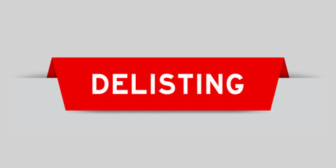 Red color inserted label with word delisting on gray background
