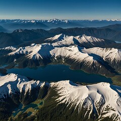 Aerial shot of snow-capped mountains with alpine lakes nestled in the valleys below, surrounded by lush evergreen forests under a clear blue sky 