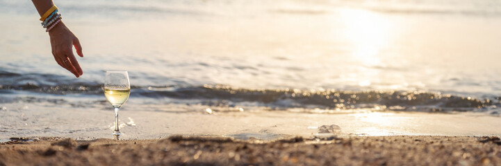 Woman with a glass of wine at the sea. Selective focus.
