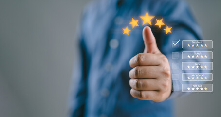 Business people or customers show satisfaction through the application on the laptop screen. By giving the most or the best satisfaction rating.Customer service satisfaction survey concept