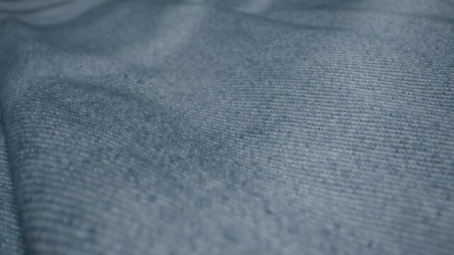 Blue textile jeans cloth texture close-up macro. Fashion fabric multicolor. Cotton casual clothes