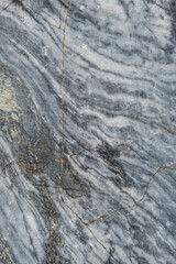 A stunning surface of gray marble exhibits intricate white veining and natural patterns, showcasing the beauty of this stone in a decorative context