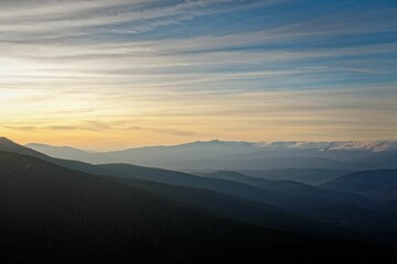 Rolling hills and mountains at sunrise