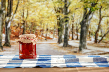 Pickled vegetables on wooden kitchen table with moody sunny autumn background.