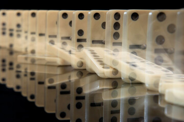 Dominoes falling in a row. Domino effect concept