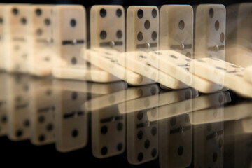Dominoes falling in a row. Domino effect concept