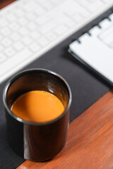 Black Mug with Coffee on Office Desk Setup