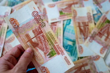Russian funds. Close-up of Russian rubles in a woman's hand. A financial idea. The background and...