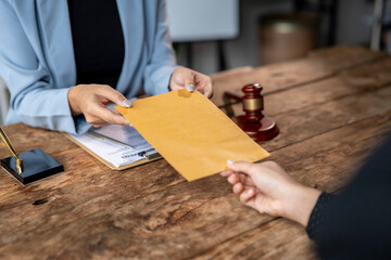 Lawyer delivering legal documents in an envelope