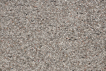 A high-resolution image of a seamless texture of small grey pebbles embedded in concrete. Perfect...