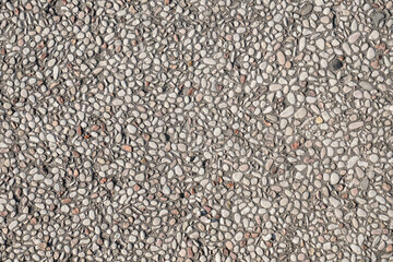 A high-resolution image of a seamless texture of small grey pebbles embedded in concrete. Perfect for backgrounds, website designs, and print projects.