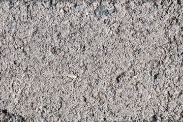 This image is a close-up texture of rough concrete with gravel. The image can be used as a background for a variety of projects, from website design to print media.