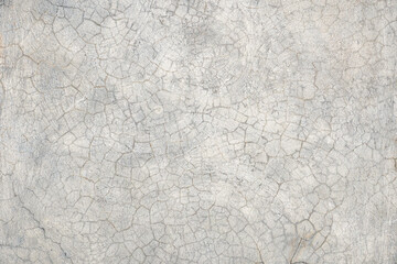 A cracked, weathered concrete surface with intricate circular patterns. The texture showcases natural aging, with visible cracks and roughness, perfect for industrial, rustic, or construction-themed d