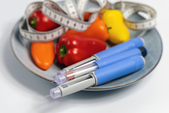  Ozempic Insulin injection pen for diabetics and weight loss on plate with vegetables