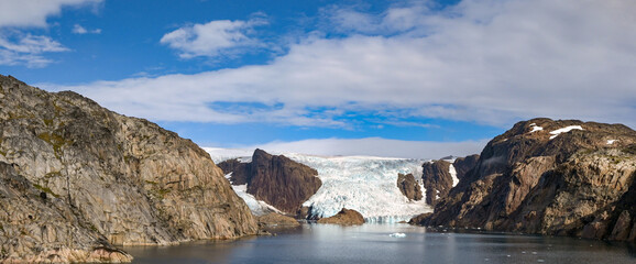 Scenic landscape view of a glacier at the water's edge of a fjord in Prince Christian Sound in Greenland © Cerib