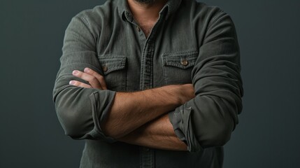 Man with arms crossed over his chest, showing defensiveness and the instinct to protect oneself in a challenging or uncomfortable situation