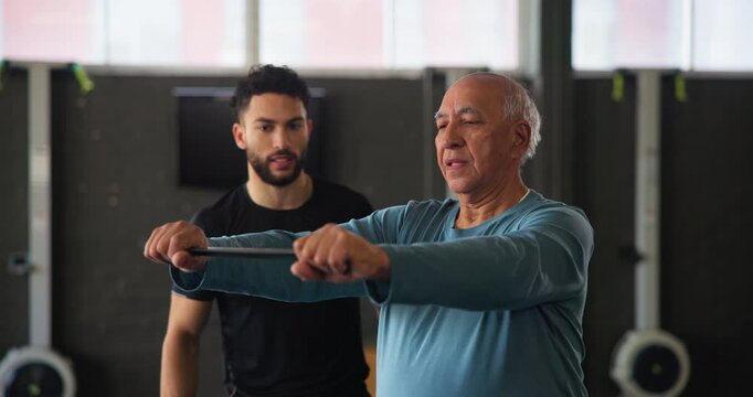 Senior man, personal trainer and aerobics class with warm up, endurance and physical training. Stretching, fitness and exercise with arm for workout, wellness and muscle in club, studio and gym
