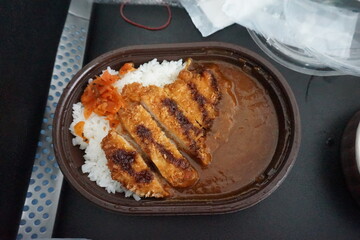 fried chicken with vegetables and sauce. a bowl of food with rice and meat on it