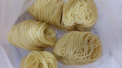 raw noodles on a white background. close up view of delicious asian food. 