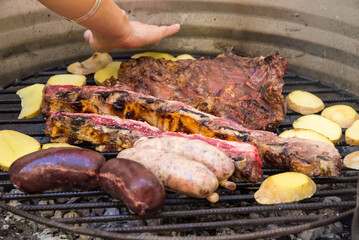 person cooking barbecue, barbecue, embers