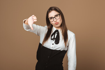 Dissatisfied Lady Expressing Disapproval with a Frowning Face and a Big Thumbs-Down Gesture....
