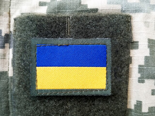 Ukrainian flag on a camouflage uniform for soldiers, pixel design, close-up