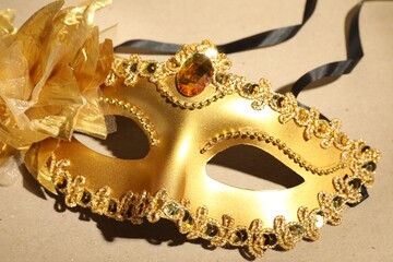 Beautiful golden carnival mask on beige background