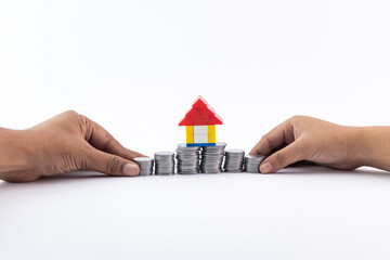 House and coins together - real estate concept.