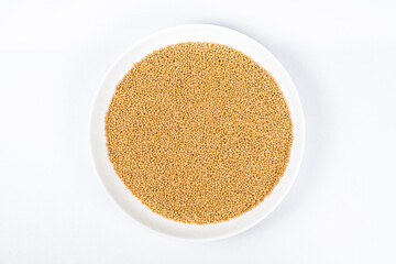 Mustard seeds on white background, natural organic seasoning, top view.
