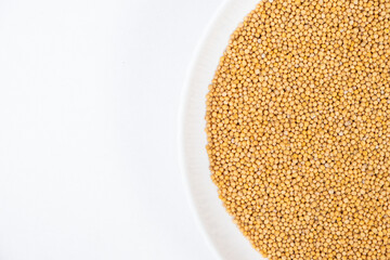 Mustard grains on white background, copy space for text