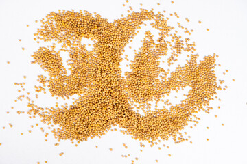 Scattered Dry Yellow Mustard Grains on White Background Top View