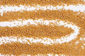 Scattered Dry Yellow Mustard Grains on White Background Top View