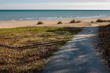 Walking down the walkway to the beach at Harrington Beach State Park, Belgium, Wisconsin to the calm waters of Lake Michigan in late October.