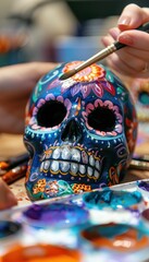 Fototapeta premium Vibrant Hand-Painted Sugar Skull with Intricate Floral Designs for Day of the Dead Celebrations