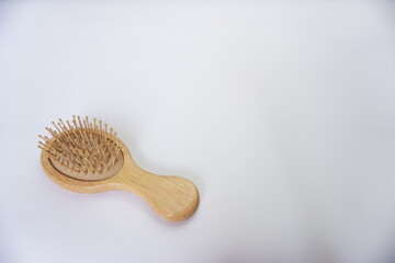 A hair comb made of wood isolated on a white background