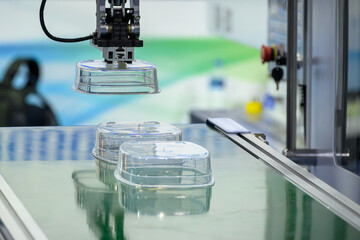 The material handling process by  robotic arm from injection machine.