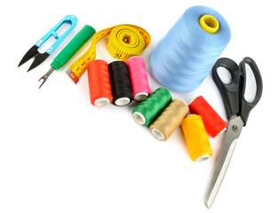 Sewing supplies (thread, scissors and measuring tape) isolated on a white. Free space for text.
