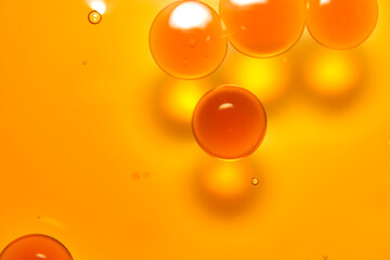 Macro close-up of oil droplets floating on water.