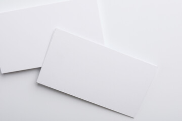 Blank business cards on light grey background, top view. Mockup for design