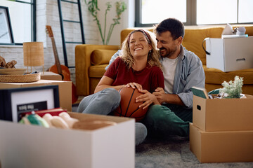 Cheerful couple enjoying after moving into new house.