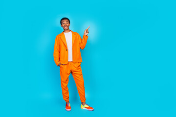 Photo of charming guy standing in street style trend clothes demonstrate empty space isolated blue color background