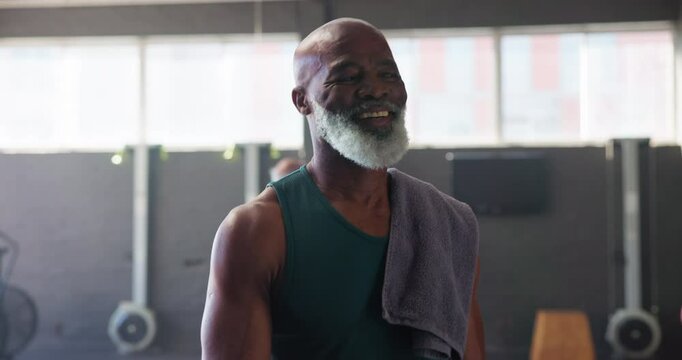 Mature man, walk and happy in gym ready for exercise, workout or training with self care. Confident, smile and satisfied or proud with routine for fitness, wellness or wellbeing for retirement health