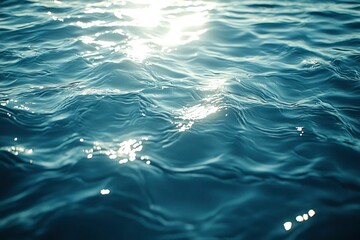 Fototapeta premium A Close-Up of the Rippling Surface of Blue Water with Sun Glints