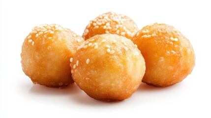Four small, golden brown, sesame seed-covered doughnuts