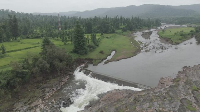 Raw footage Aerial view of river with Dam near agriculture field Located in Mayadevi Temple in Dang Gujarat.  