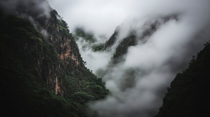 A valley filled with mist, heavy fog clinging to the mountainsides, the air cold and damp