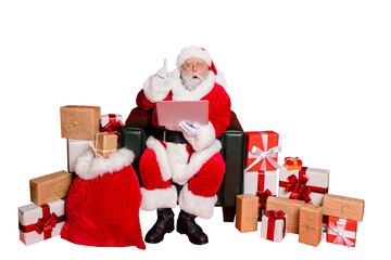 Full body photo of impressed santa claus with eyewear eyeglasses spectacles use device have genius thoughts wearing headwear hat belt isolated over red background