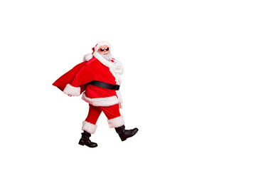 Full length photo of dreamy fat funny santa claus have eyeglasses go carry bag with presents on midnight isolated over red background