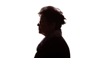 Dark silhouette of an elderly woman, pensioner in glasses - isolate